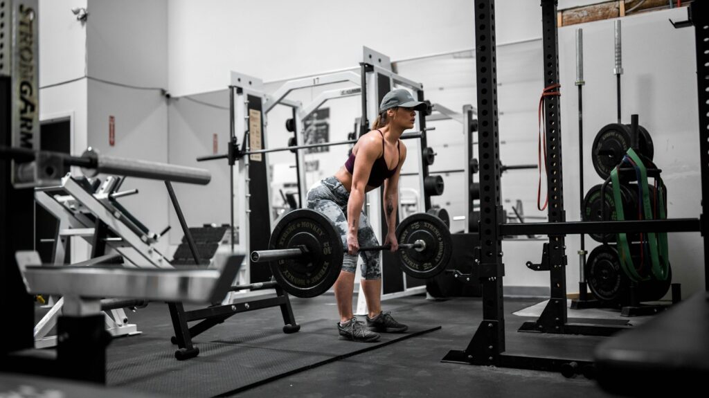 man in orange tank top and black shorts doing exercise